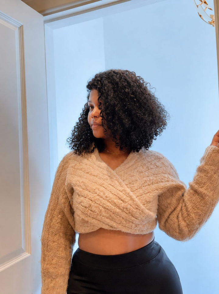 Woman wearing a curly wig , standing by the door
