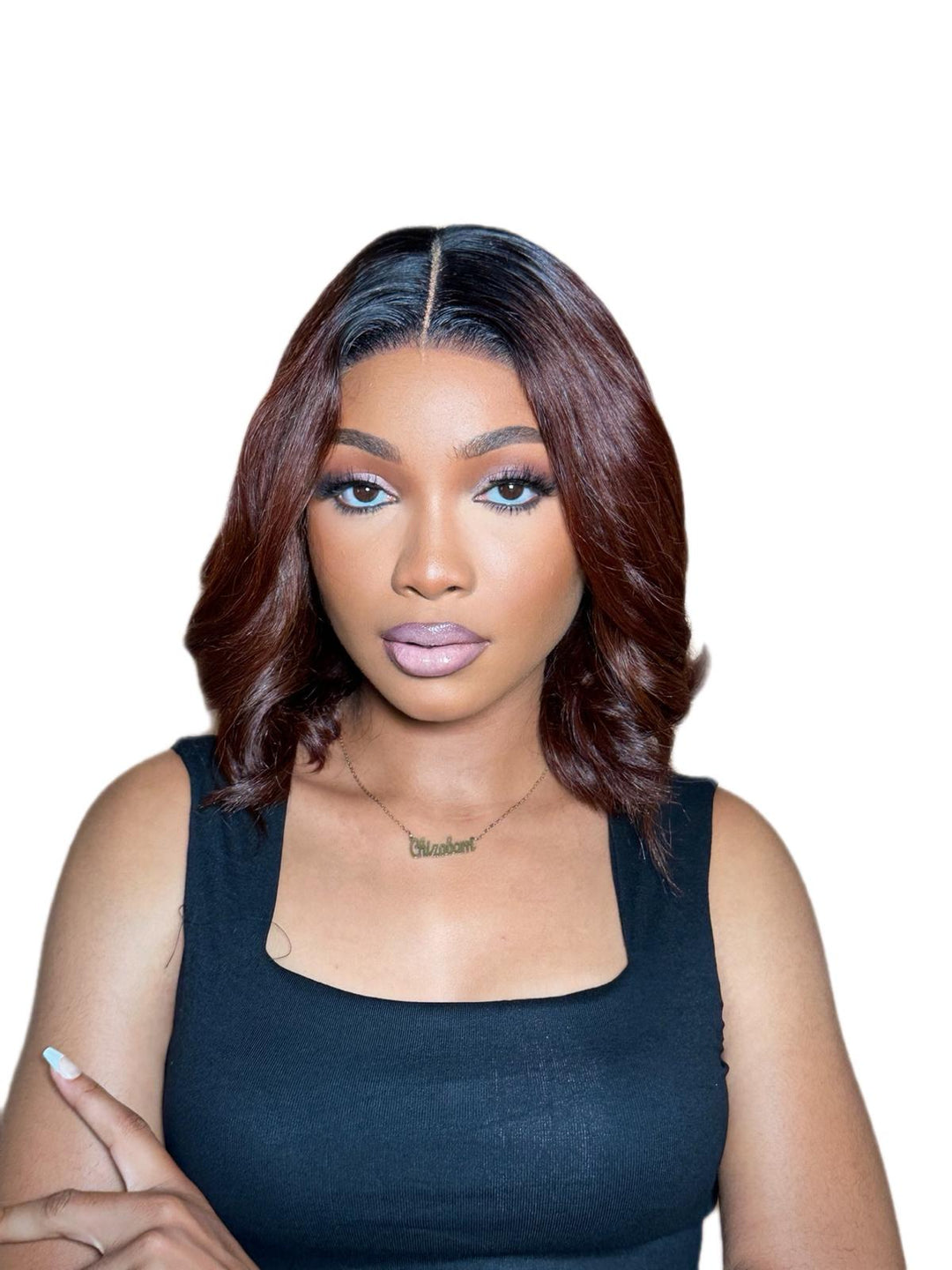 Woman with styled gluless bob wig wearing a black top on a white background