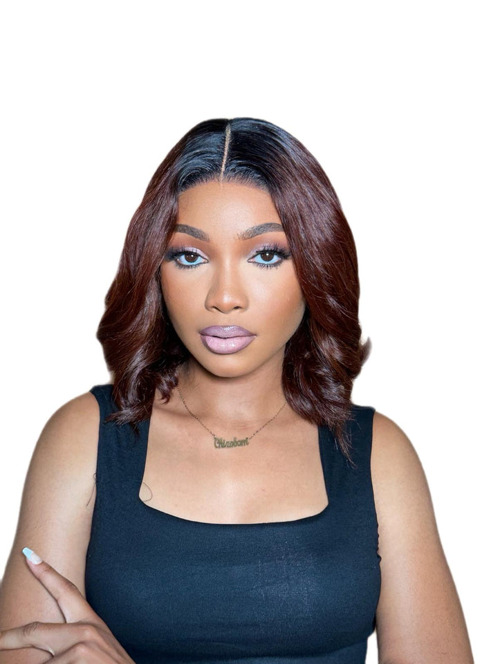 Woman with styled gluless bob wig wearing a black top on a white background